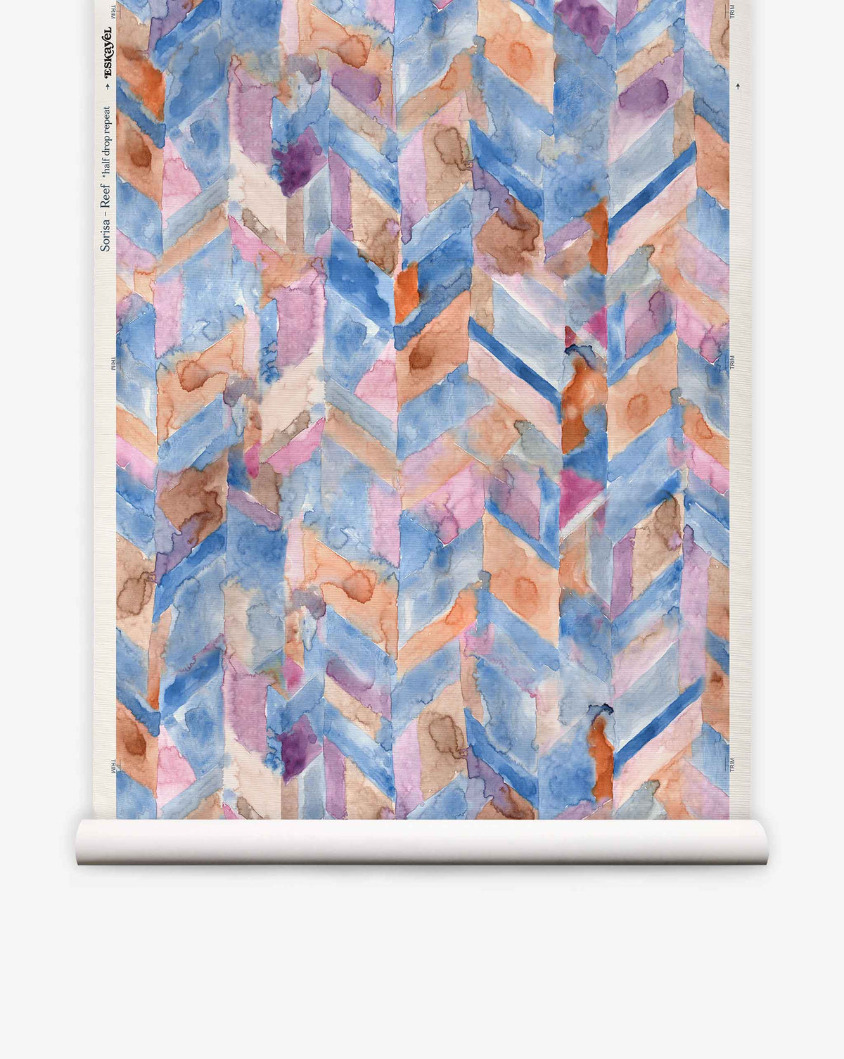 Sorisa Grasscloth||Reef features a watercolor-style geometric chevron pattern in blue, pink, purple, and orange on a rolled sheet of paper.