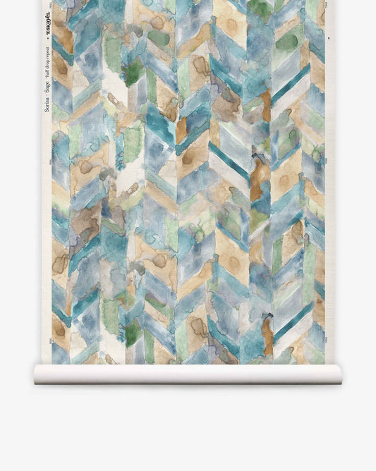 Sorisa Grasscloth||Sage wallpaper roll features an abstract watercolor chevron pattern in blue, beige, and green with textured, overlapping brush strokes.