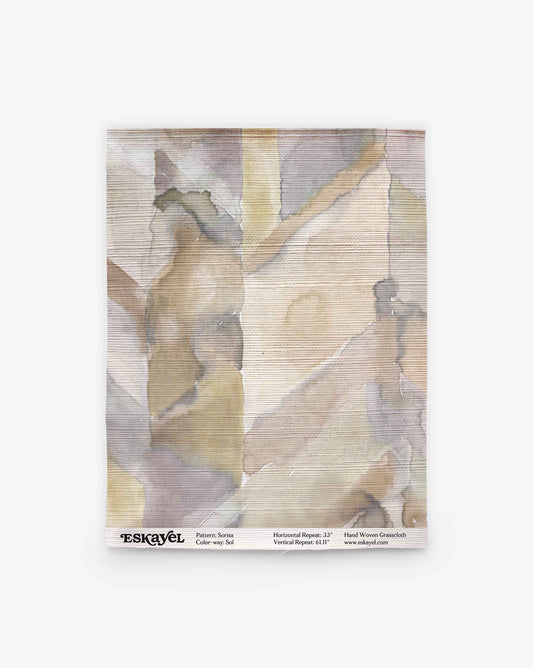 A fabric swatch in gray, beige, and brown abstract pattern; text below shows pattern, color, and brand—Order a Sorisa Grasscloth Sample||Sol to see up close.