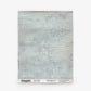 A square textile swatch in a light blue-gray hue with subtle horizontal lines and a mottled, grasscloth-like texture, labeled “Stratus Grasscloth||Sky” at the bottom.