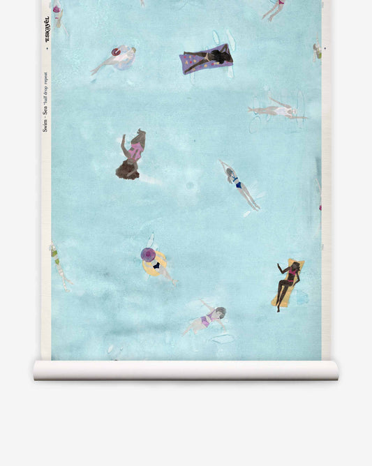 Swim Grasscloth||Sea coastal wallpaper featuring an illustration of people swimming and floating on pool floats in light blue water.