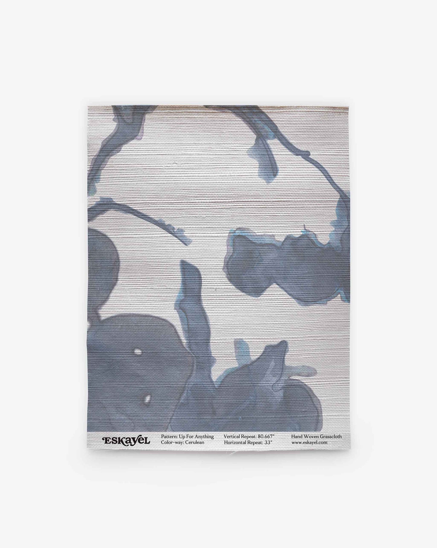 A rolled-up Up for Anything Grasscloth Sample||Cerulean wallpaper sample featuring a blue and gray abstract floral pattern on a light background, displayed vertically with product details along the bottom edge. Order a sample to experience the design and quality firsthand.