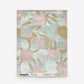 Yaya Grasscloth Sample in Brisa, featuring a grid of soft pink, light blue, and tan abstract floral-like shapes.