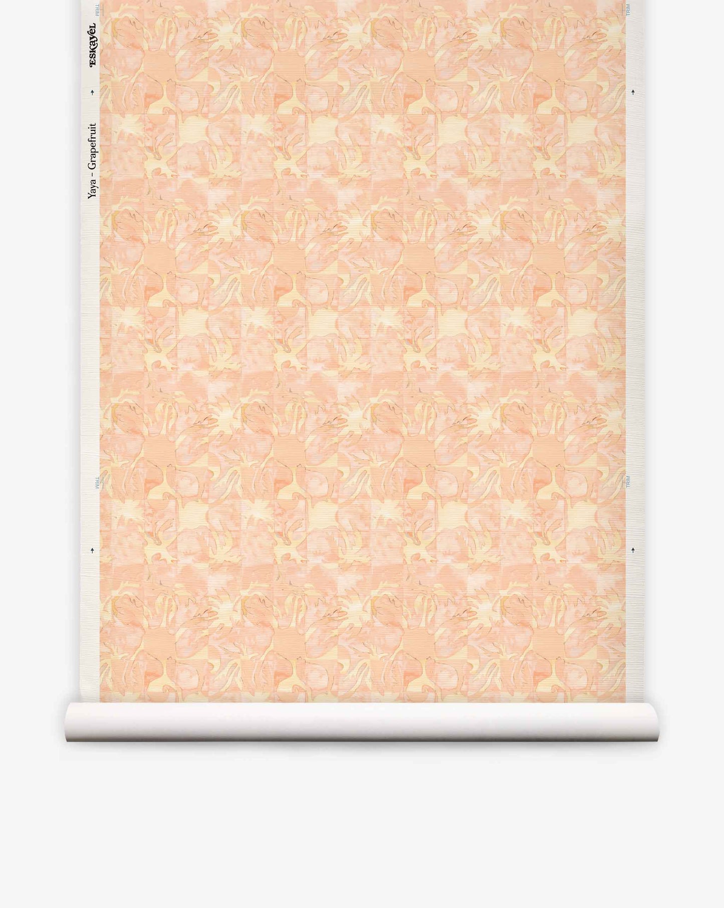 Yaya grasscloth wallpaper in Grapefruit on a roll — beach-themed graphic botanical fabric in pale peach with light yellow highlights | Eskayel