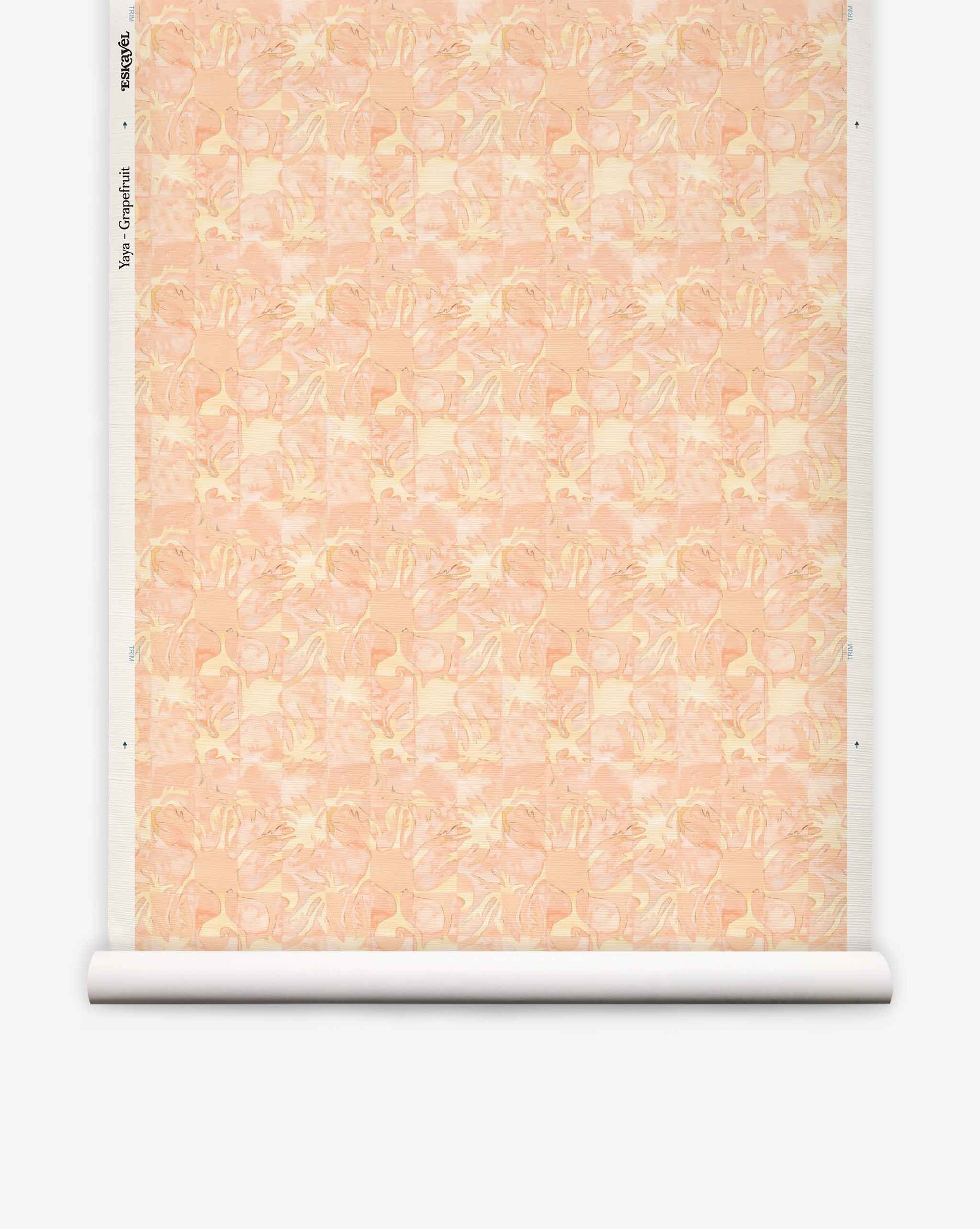 Yaya grasscloth wallpaper in Grapefruit on a roll — beach-themed graphic botanical fabric in pale peach with light yellow highlights | Eskayel