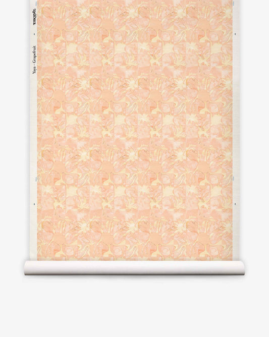 Yaya grasscloth wallpaper in Grapefruit on a roll — beach-themed graphic botanical fabric in pale peach with light yellow highlights | Eskayel