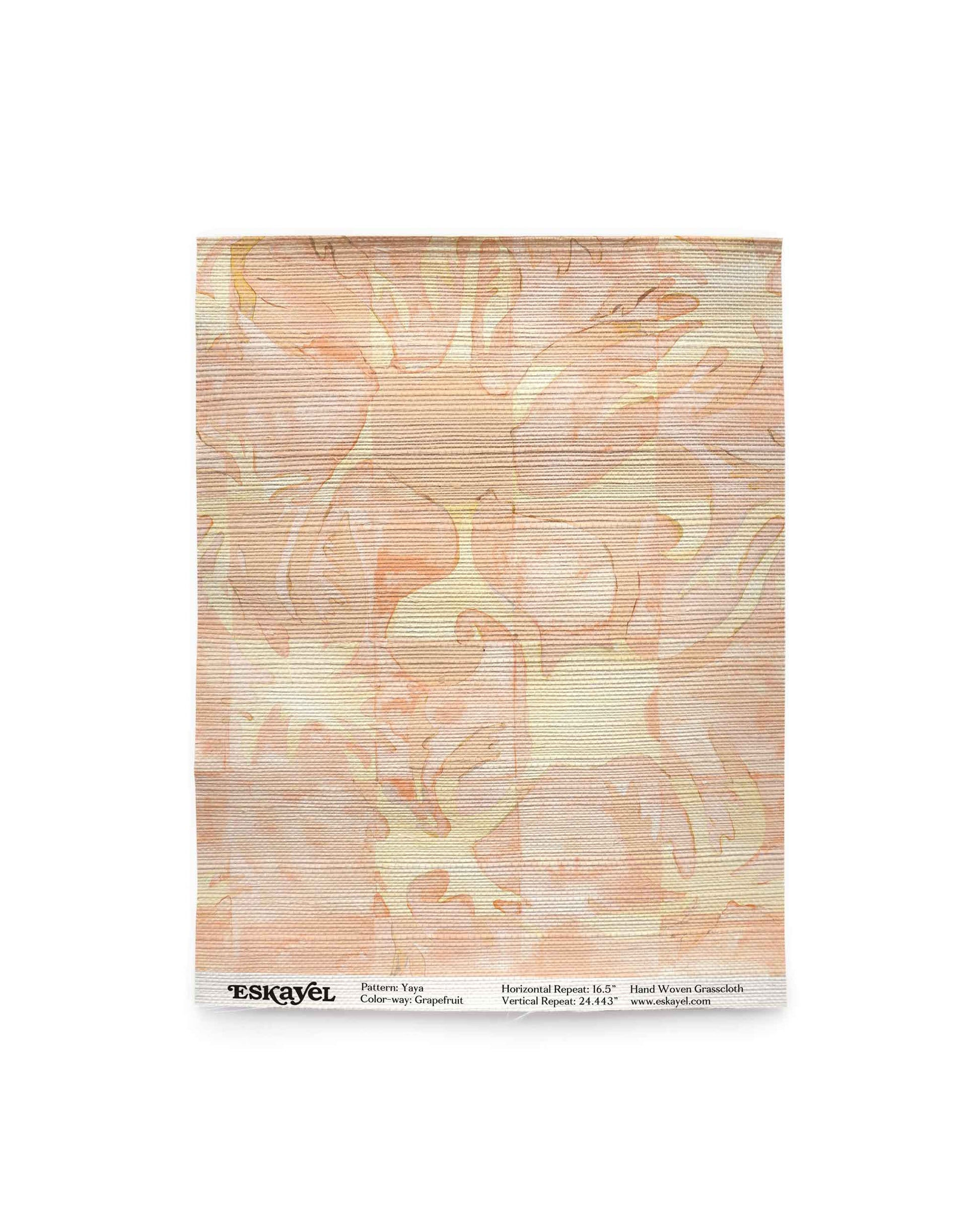 Yaya grasscloth wallpaper in Grapefruit as a swatch — beach-themed graphic botanical wallpaper in pale peach with light yellow highlights | Eskayel