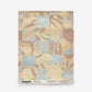 Yaya Grasscloth Sample in Husk, shown as a swatch with abstract tan and light blue organic shapes, an order button, and product information at the bottom.