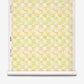 A roll of Yaya Grasscloth||Limeade wallpaper featuring a checkered pattern of light green, yellow, and soft orange abstract floral shapes.