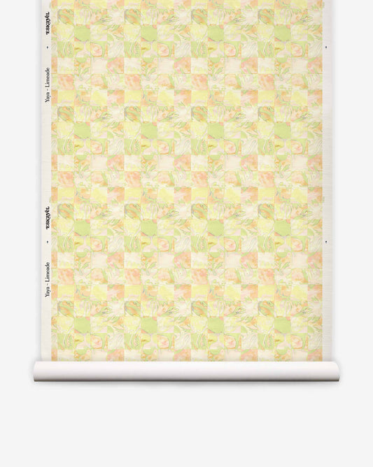 A roll of Yaya Grasscloth||Limeade wallpaper featuring a checkered pattern of light green, yellow, and soft orange abstract floral shapes.