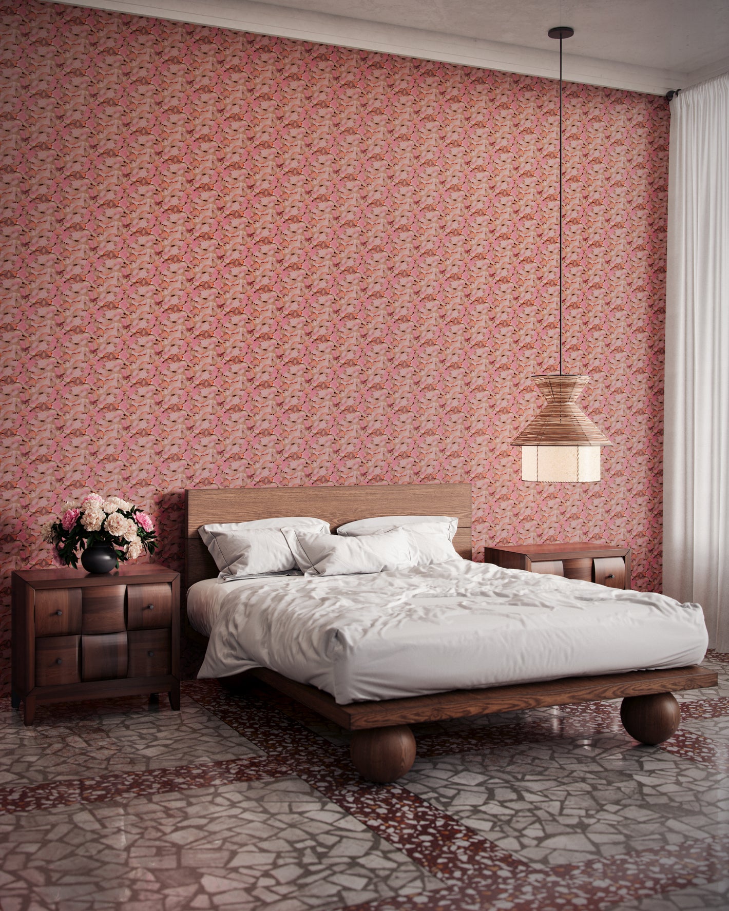 Orbs wallpaper in flamingo in a bedroom with a large bed, low hanging ceiling light, and two side tables.