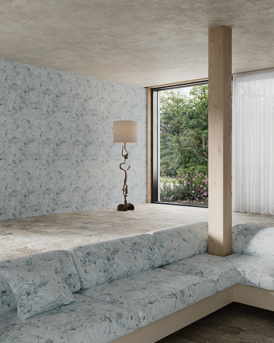 A living room appointed with Eskayel’s Plumeria Shadows wallpaper pattern in the Shadow colorway featuring a grey palette.