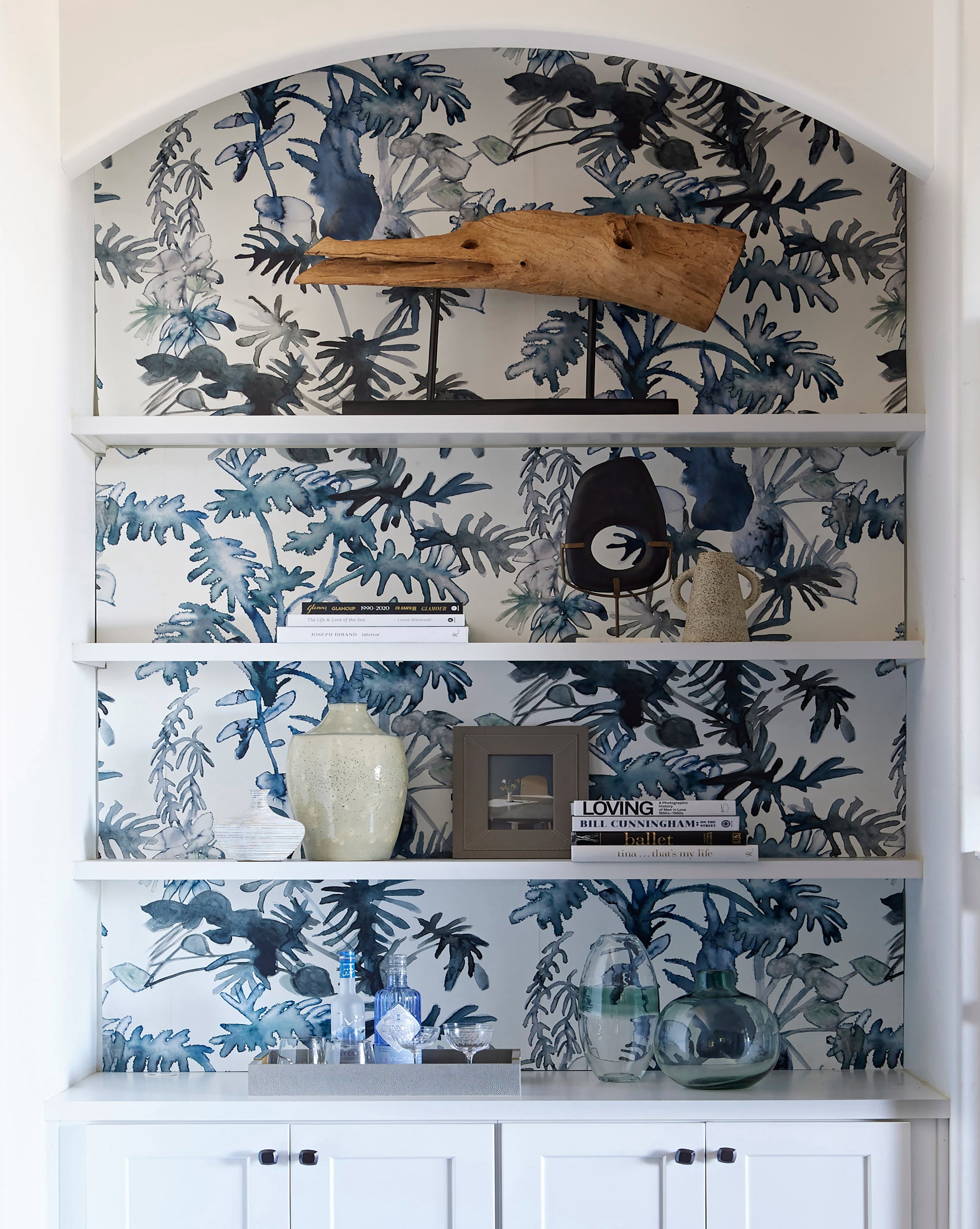 A luxury white shelf with Topiary Wallpaper Indigo