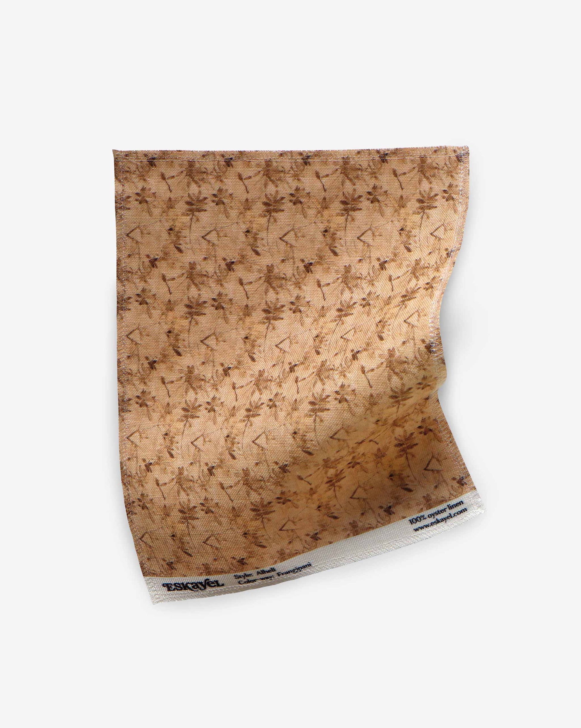 A swatch of Eskayel’s Alhelí, a tiny repeating pattern for fabric, in the beige-based colorway Frangipani.