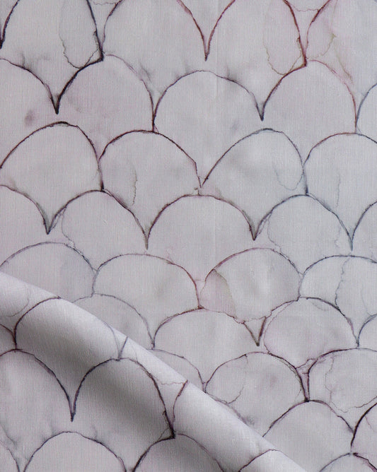Baby Scallops fabric in Pomegranate introduces tones from mauve to blue into a geometric pattern of overlapping curves.
