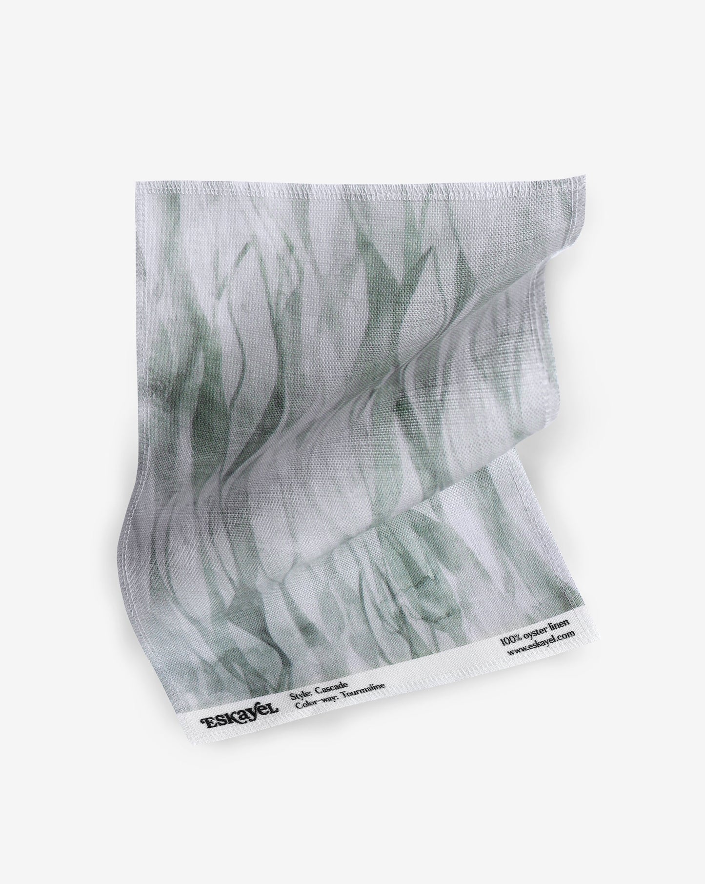 A fabric with our cascade pattern in tourmaline featuring a design that explores positive and negative space to evoke a feeling of vertical motion in shades of green.