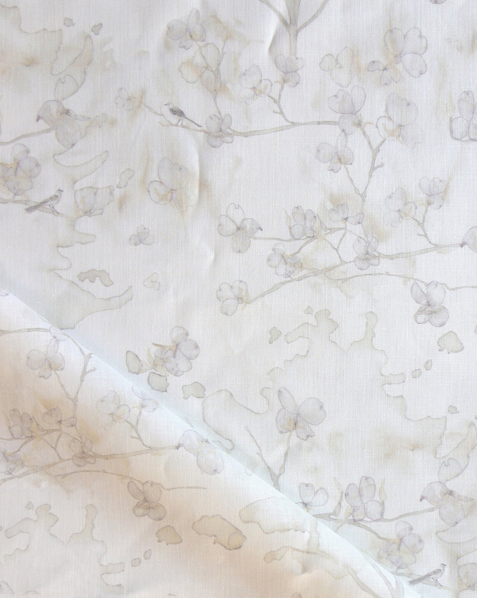 Dogwood Dreams is a watery pen-and-ink design. As luxury fabric, Flax provides a colorway of beige.