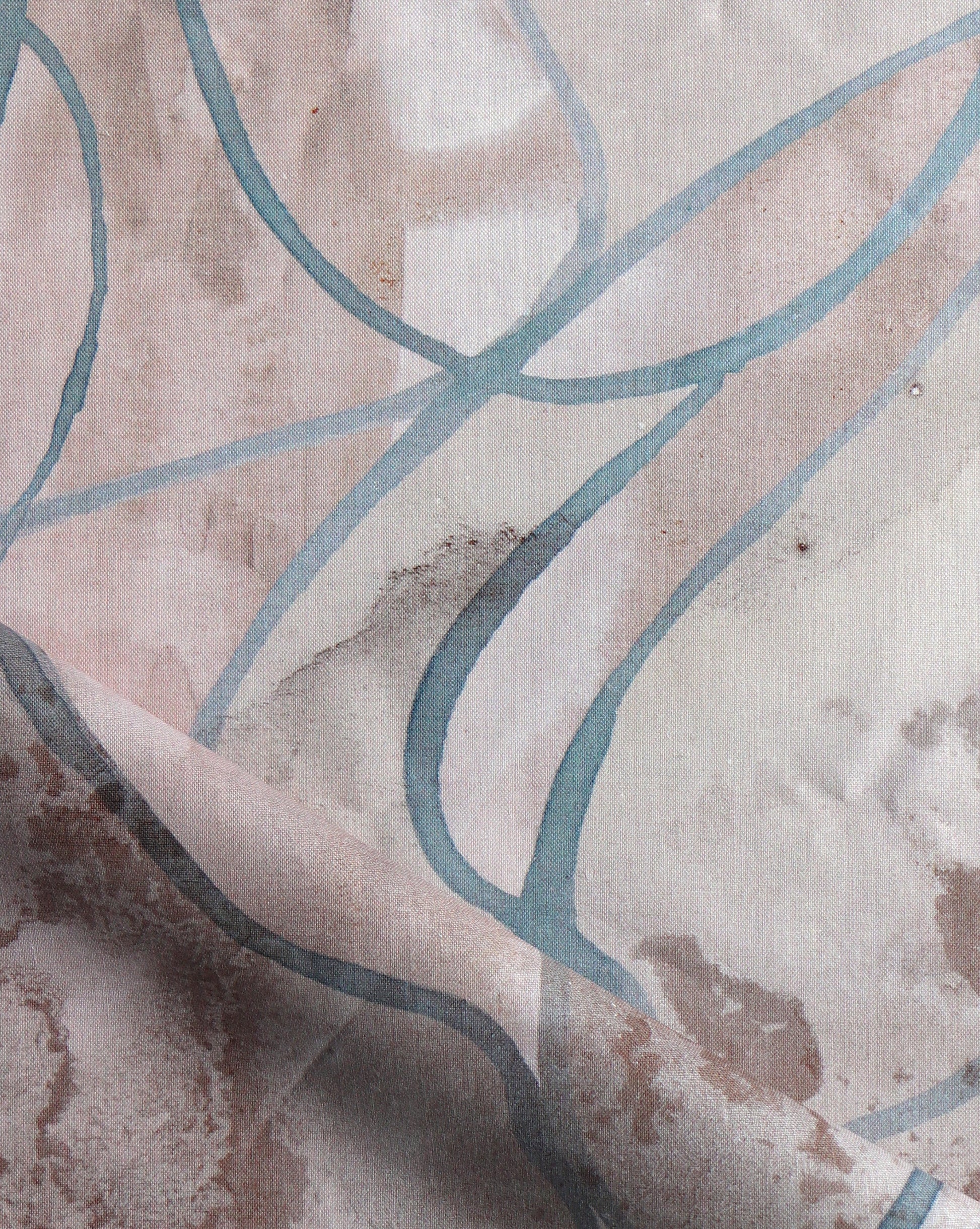 Watercolor strokes of beige, grey, and brown feature in Hibiscus Lily fabric in Amber. 