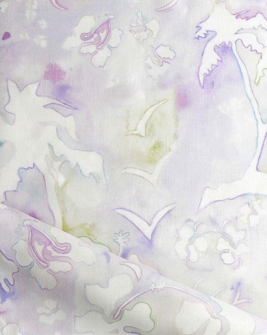 A high-end fabric, Kokomo Fabric||Cay, with a soft pastel-colored, abstract floral and palm tree pattern reminiscent of a tropical paradise, featuring shades of lavender, pink, and green. The design elements are subtle and watercolor pencil-like.