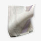A single Majorelle Fabric||Blanca luxury microfiber cloth with a tag displaying text, isolated on a white background.