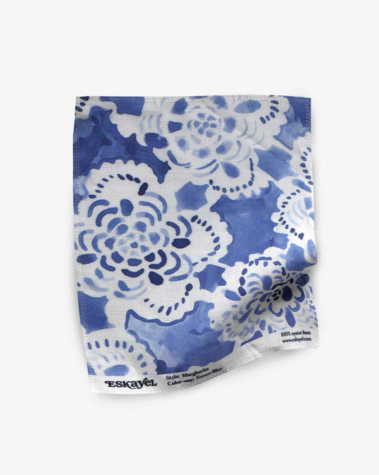 A swatch of Margherita in Fresco Blue shows the medium-sized repeat fabric – a floral watercolor design – in shades of blue.