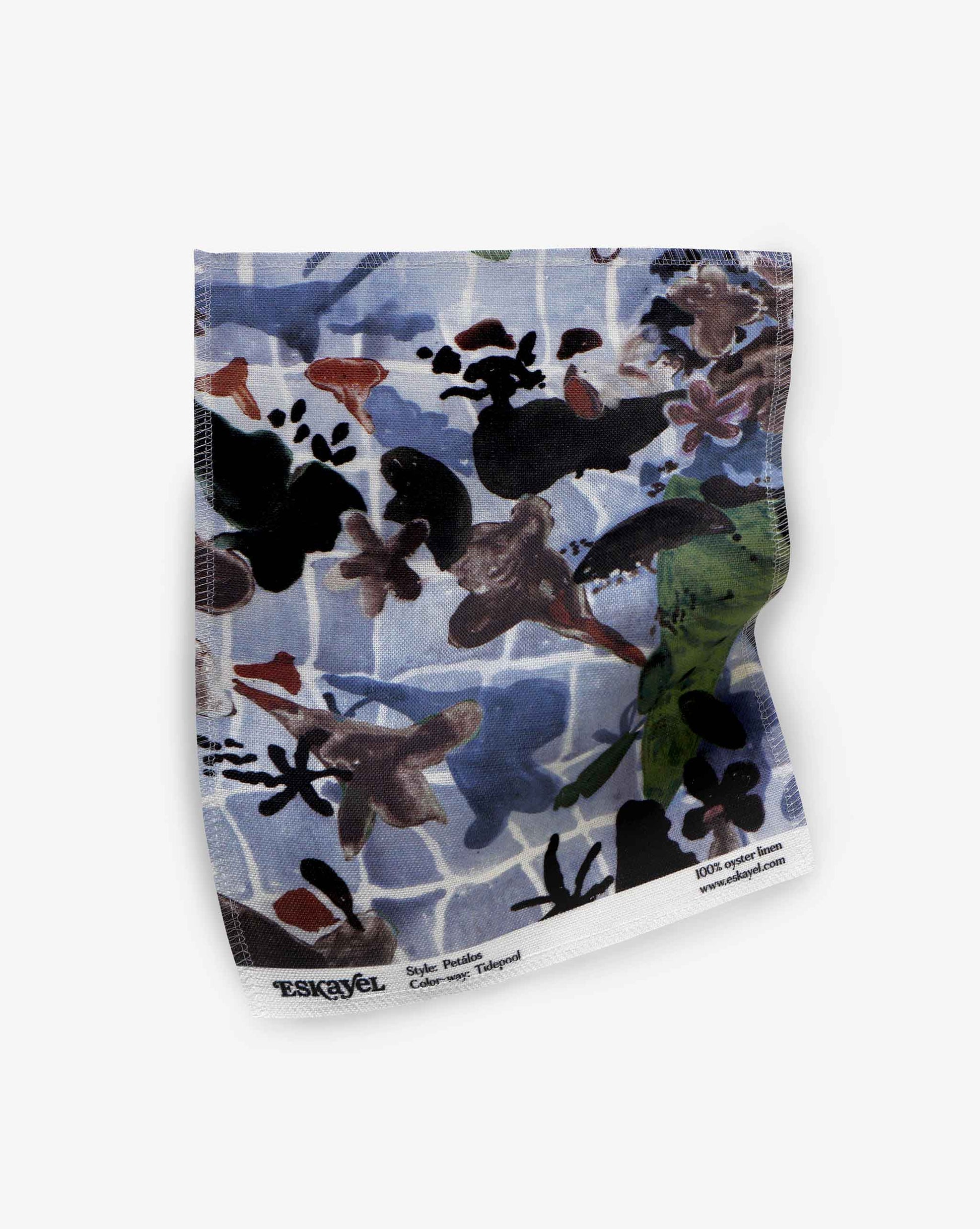A fabric swatch of our Pétalos pattern in the color way tide pool with an immersive blue palette.