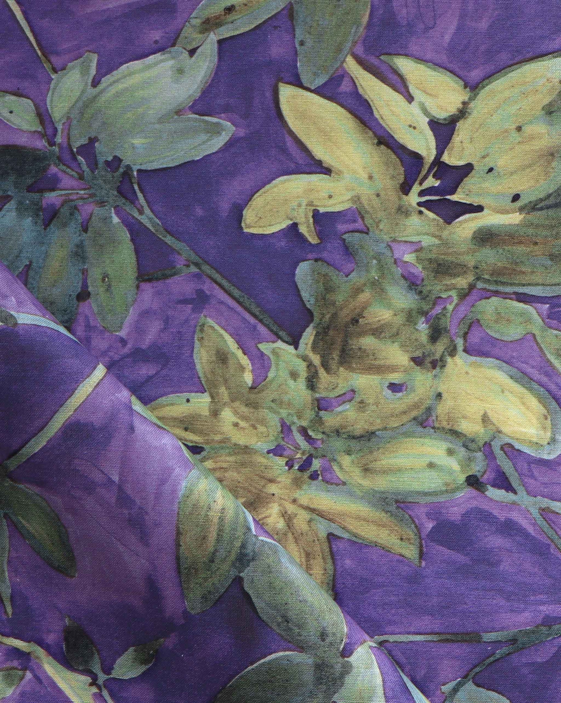 A detail photo of Eskayel’s Plumeria Shadows fabric pattern in Eggplant, a colorway of purple with green tones.