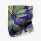 A swatch of Eskayel’s Plumeria Shadows fabric pattern in Eggplant, a colorway of purple with green tones.