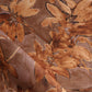 A detail photo of Eskayel’s Plumeria Shadows fabric pattern in Golden Hour, a colorway of rich brown and gold tones.