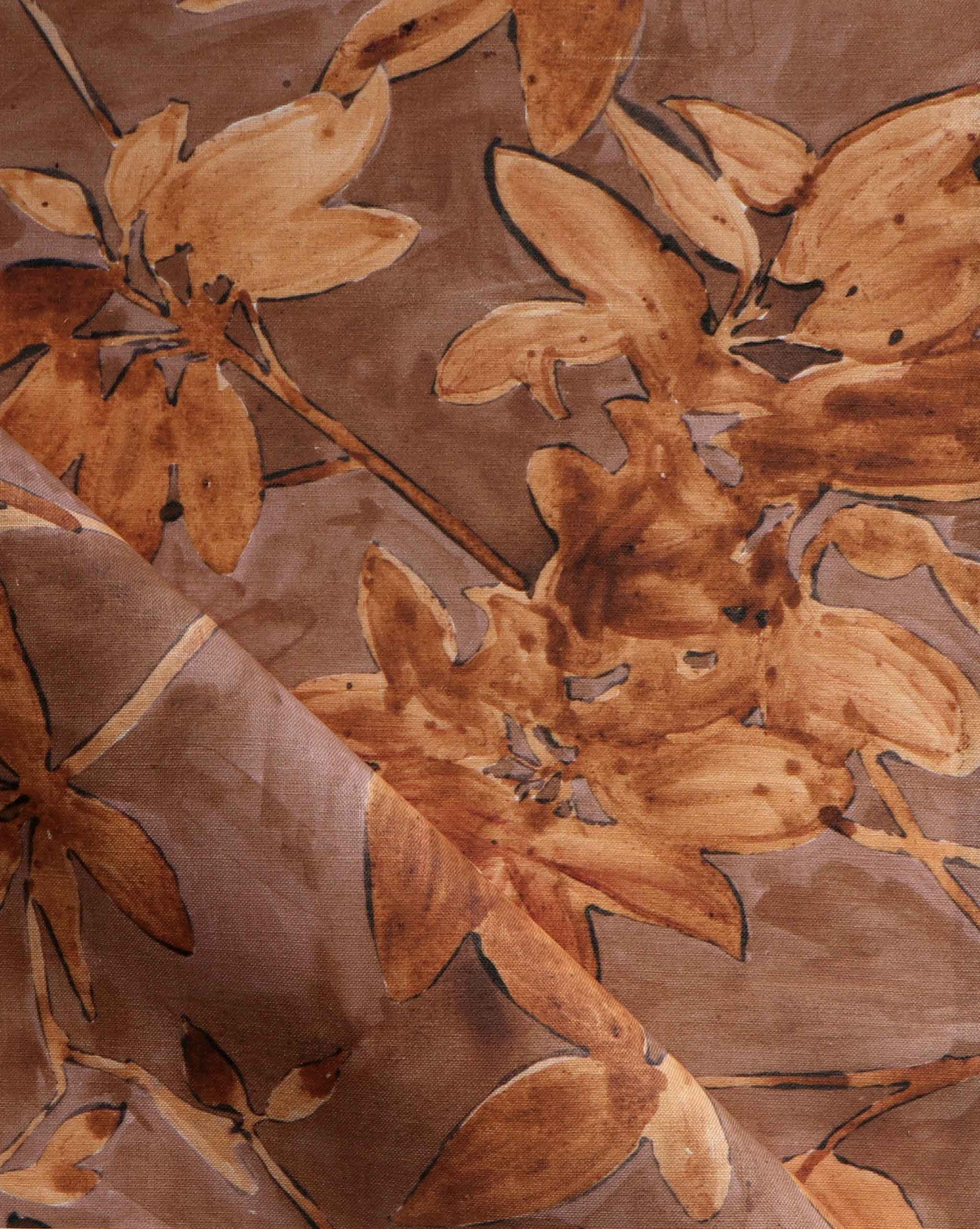 A detail photo of Eskayel’s Plumeria Shadows fabric pattern in Golden Hour, a colorway of rich brown and gold tones.