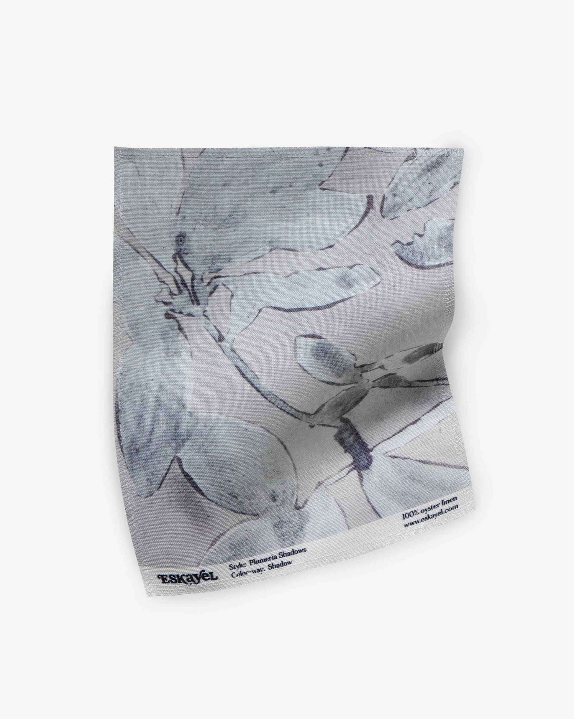 A swatch of Eskayel’s Plumeria Shadows fabric pattern in the Shadow colorway featuring a grey palette.