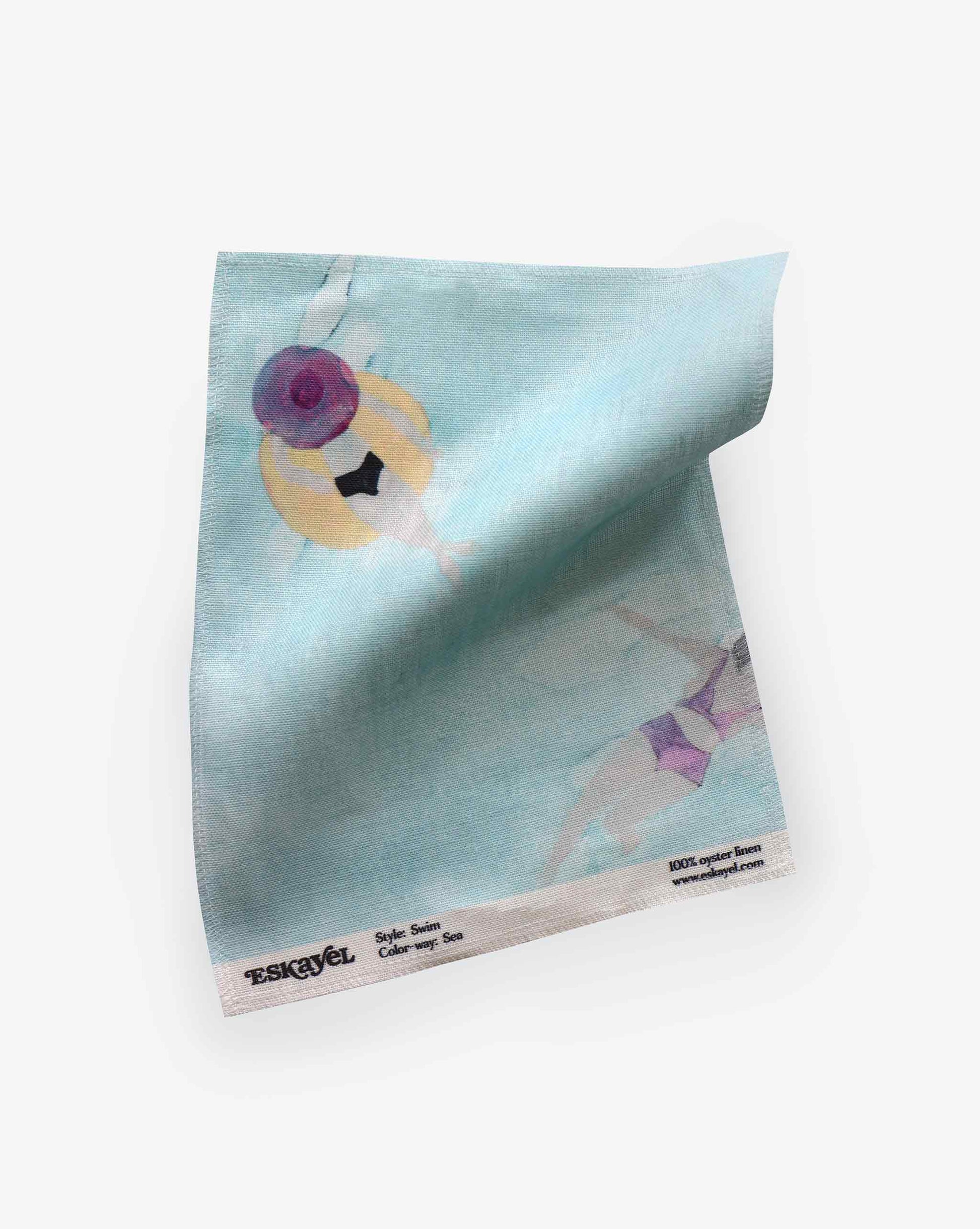 A fabric swatch with our Swim pattern in Sea featuring a design inspired by the sweet feeling of water against the skin with watercolor figures appearing against a light blue background.