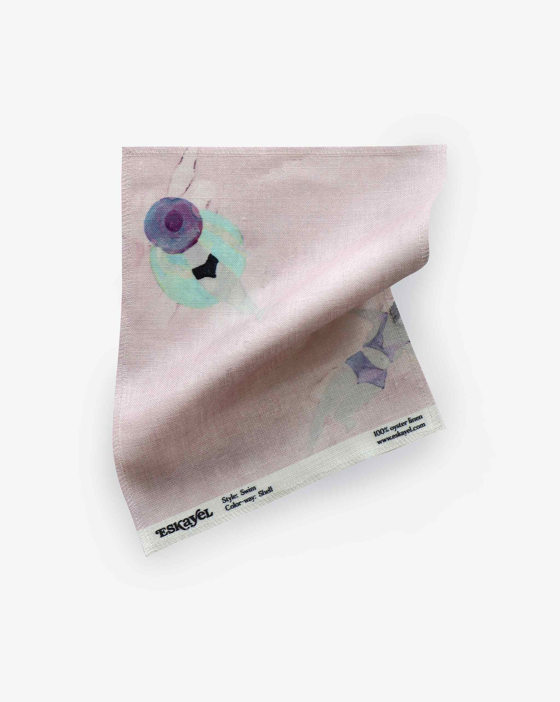 A fabric swatch with our Swim pattern in Shell featuring a design inspired by the sweet feeling of water against the skin with watercolor figures appearing against a light pink background.