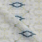 A close up of a white fabric from The Knitting Fabric Sand with a blue and yellow pattern