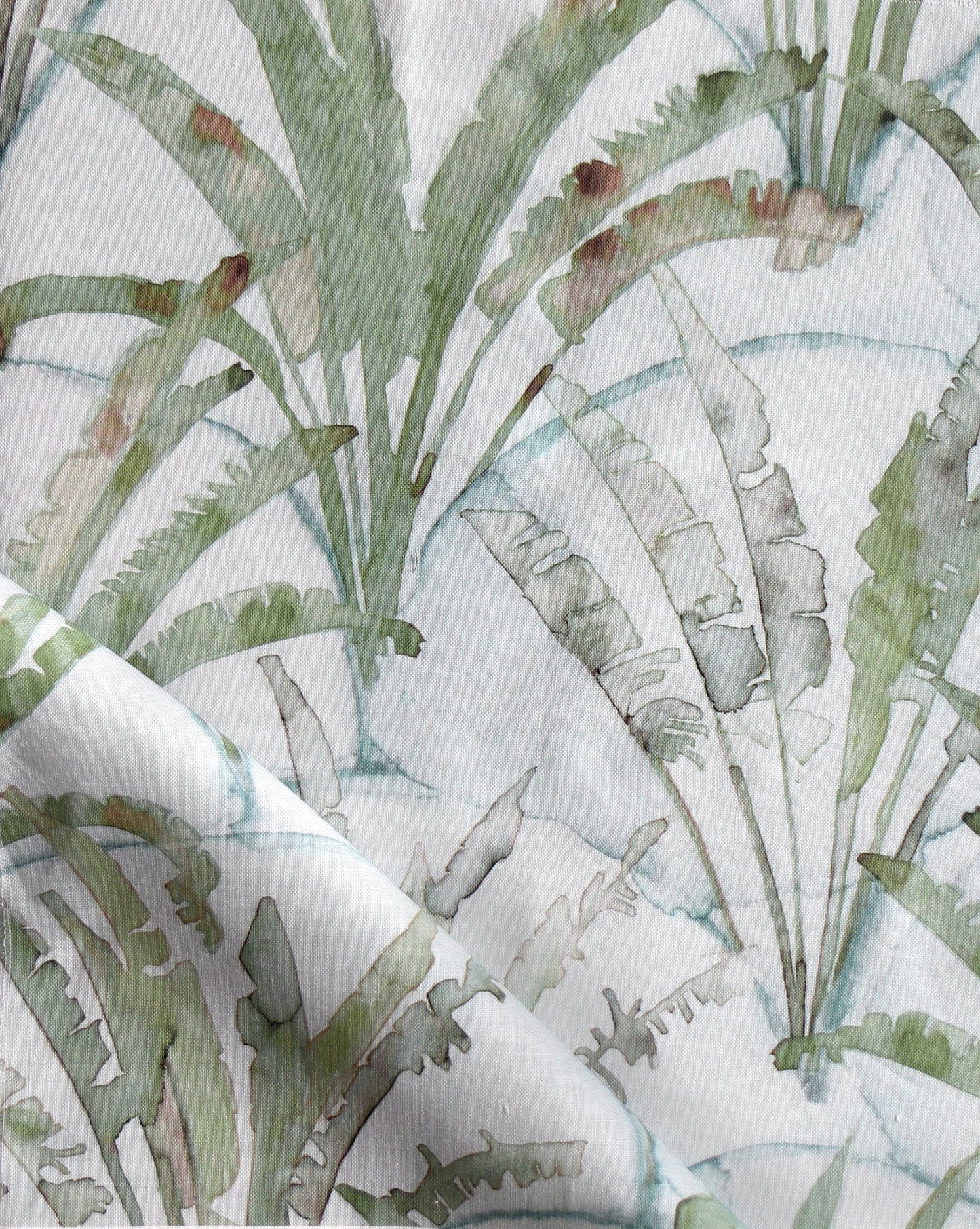 Travelers Palm displays fan-like trees arrayed against a scallop background In our Sage colorway, the palette is green and blue