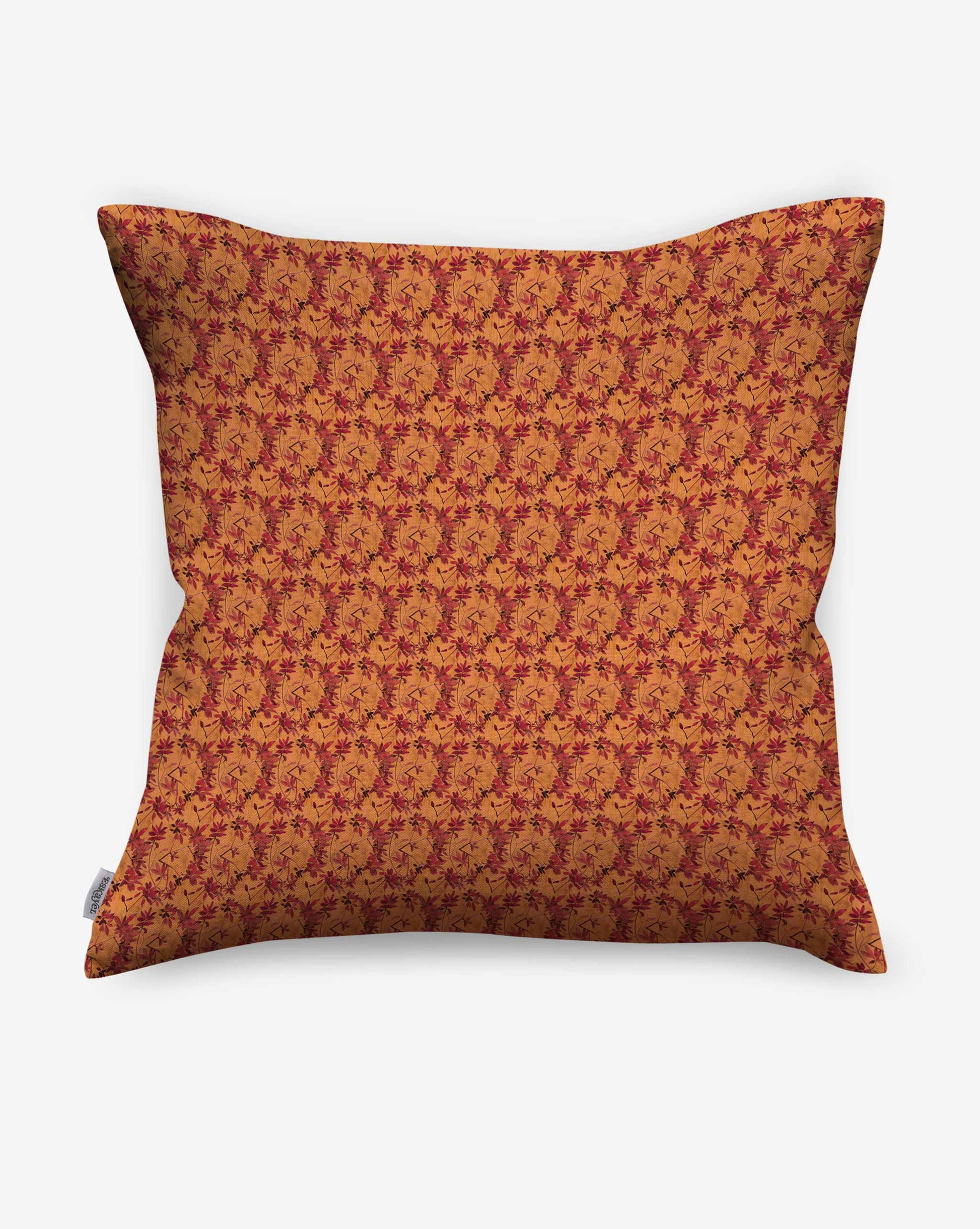 Pillows in Eskayel’s Alhelí, a tiny repeating pattern inspired by tropical living, in the orange-based colorway Golden Hour.