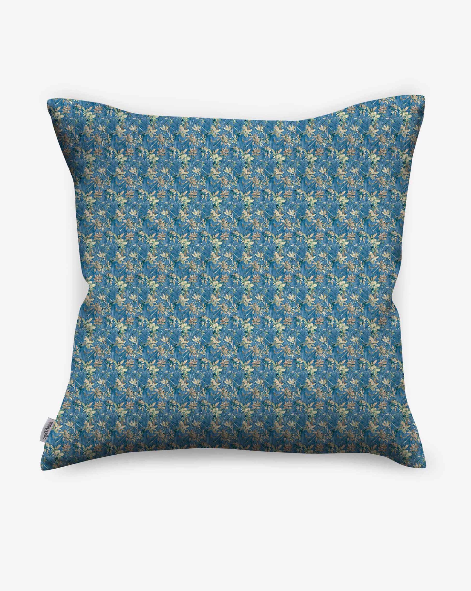 A pillow in Eskayel’s Alhelí fabric, a tiny repeat pattern inspired by tropical light, shown in the blue-based Tide Pool colorway.