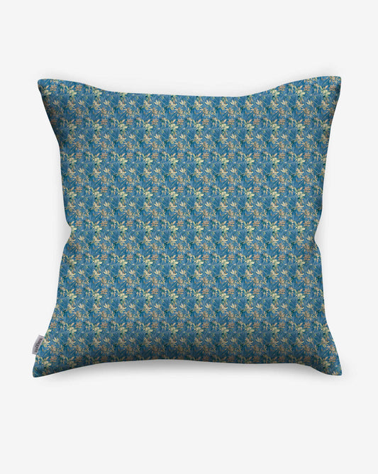 A pillow in Eskayel’s Alhelí fabric, a tiny repeat pattern inspired by tropical light, shown in the blue-based Tide Pool colorway.