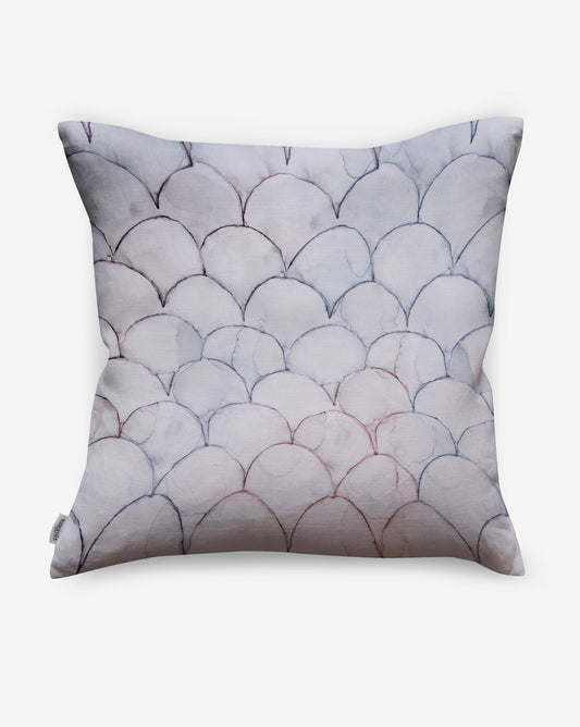 Baby Scallops pillows in Pomegranate present tones ranging from mauve to blue as a geometric pattern of overlapping curves