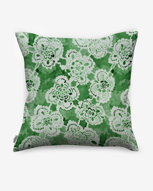 The Margherita Pillow||Arugula is a square throw pillow with a green watercolor background and white lace design, ideal for adding a fresh touch to any decor.