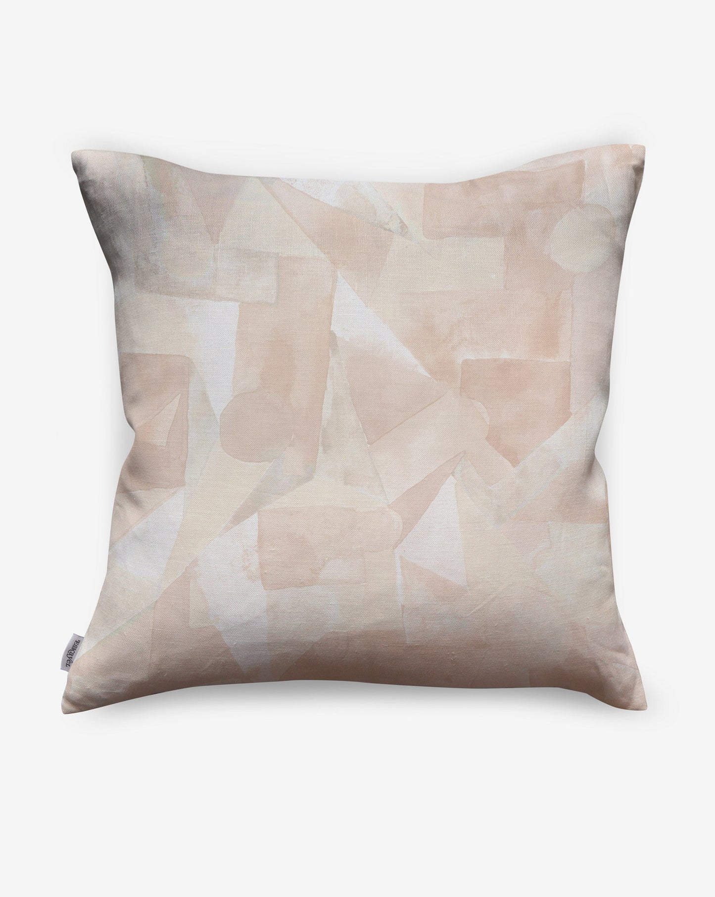 In Pieces pillows in Quartz, beige blocks of pigment depict puzzle pieces. 