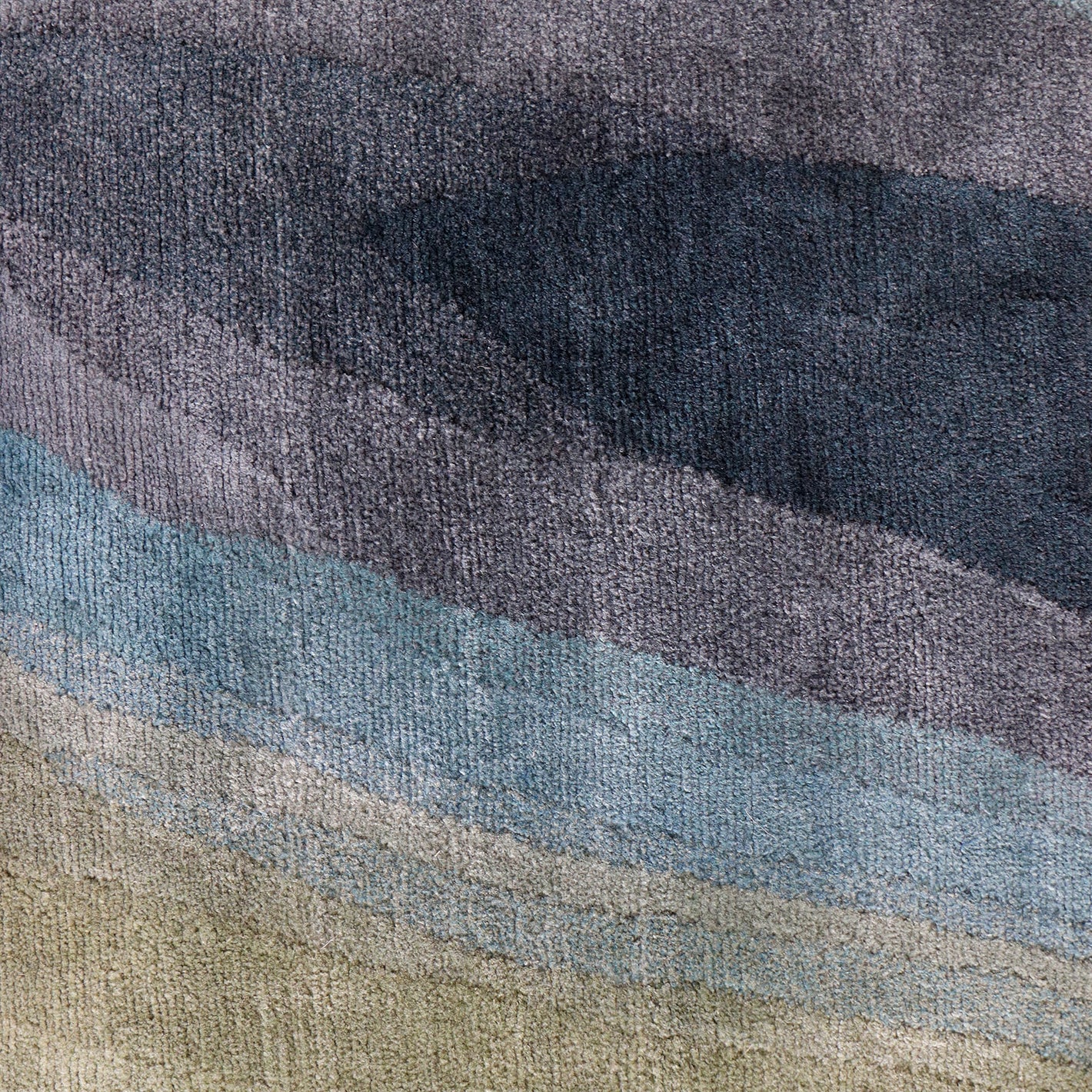 A close up image of a blue and grey rug