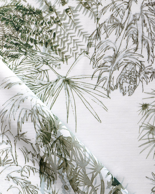 A close up of a white and green fabric with ferns on it from the Domenica Performance Fabric Brush from the Salentu Collection