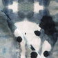 A close up of a black and white ink stain on a piece of Dynasty Performance Fabric||Indigo.