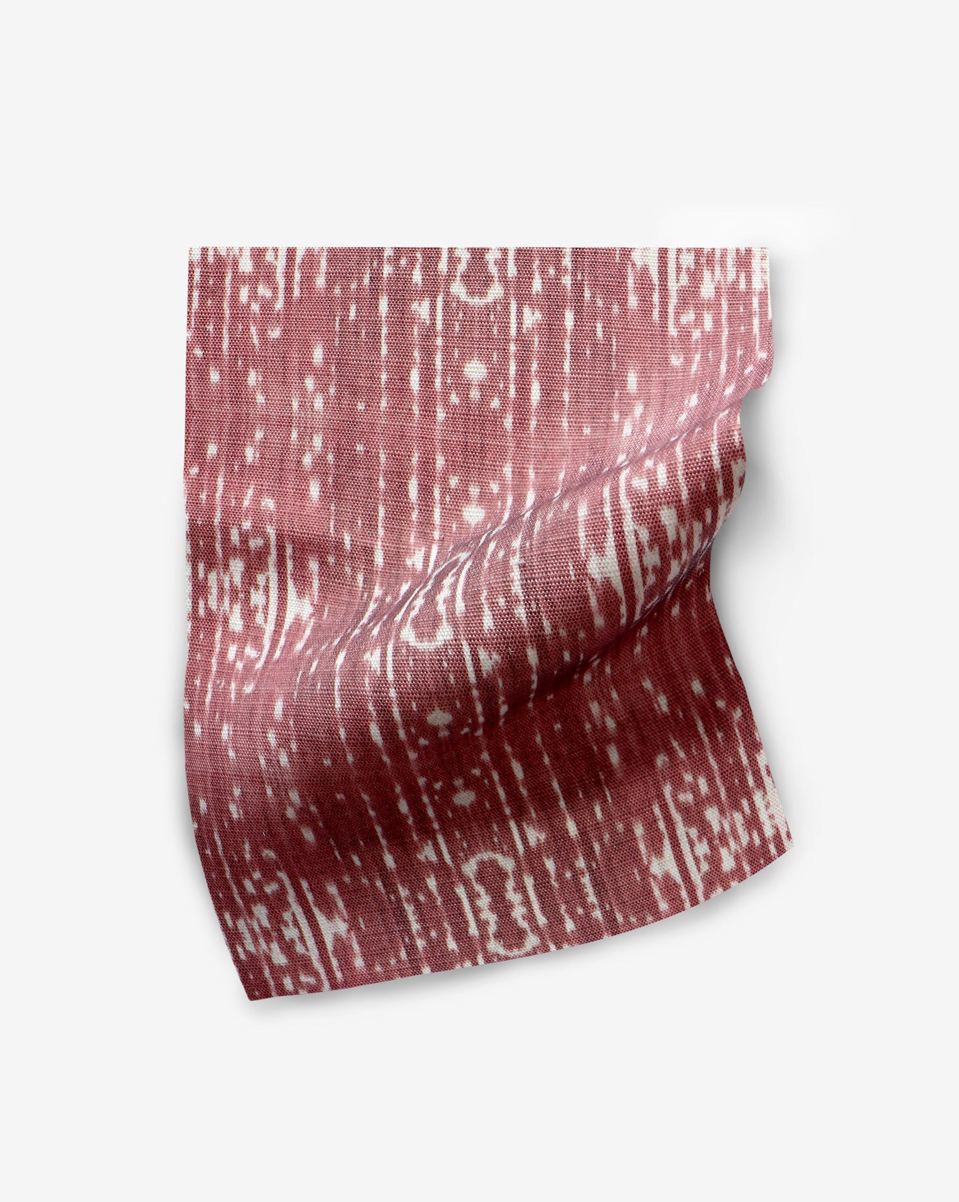 A red and white striped fabric featuring Omaha Kinship Performance Fabric Morinda Ikat on a white background