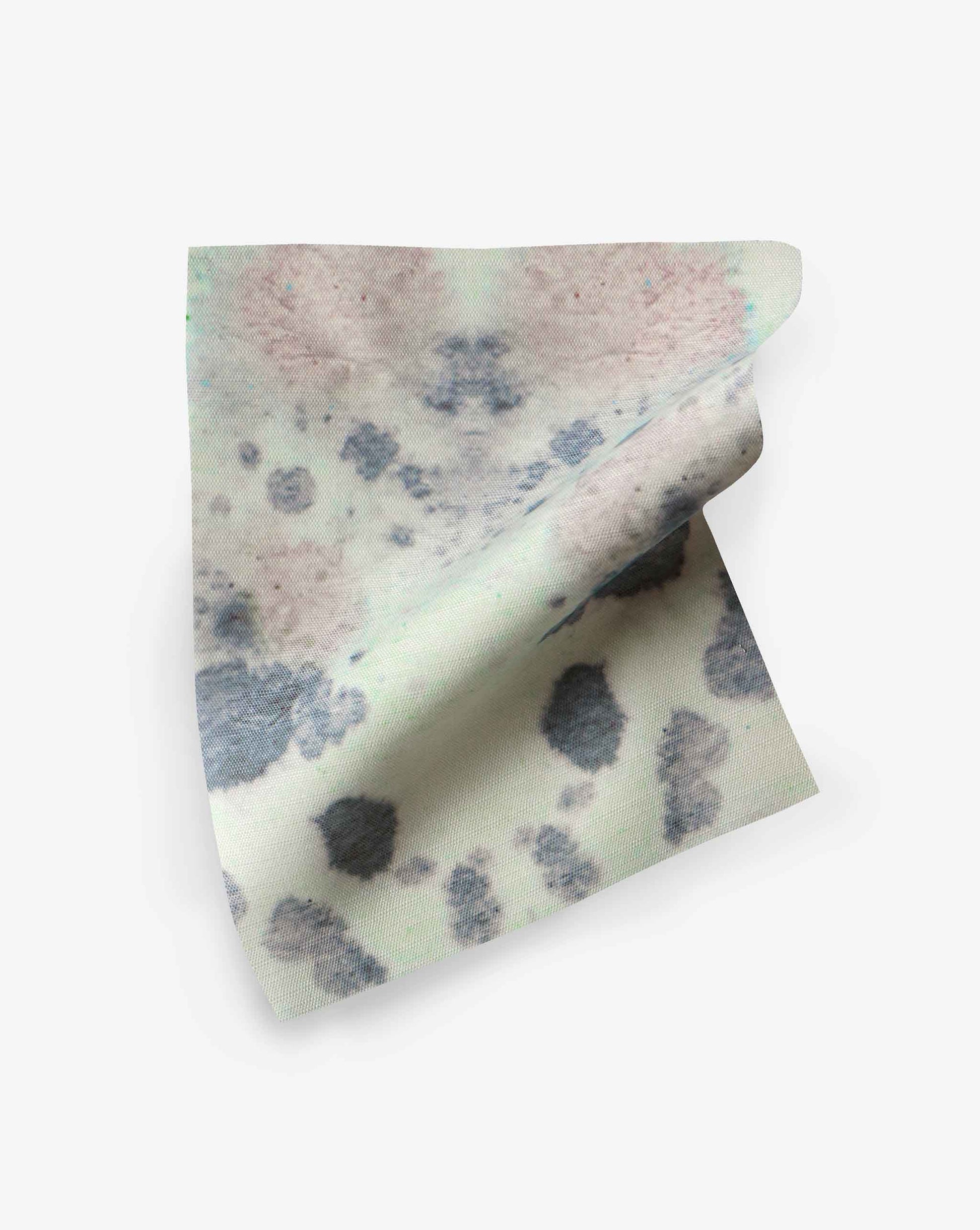 A piece of fabric with a tie-dye pattern in shades of pink, blue, and gray, displayed on a white background. Ideal for high-traffic applications, the Species Performance Fabric||Hide resists ink bleed while maintaining its vibrant colors.