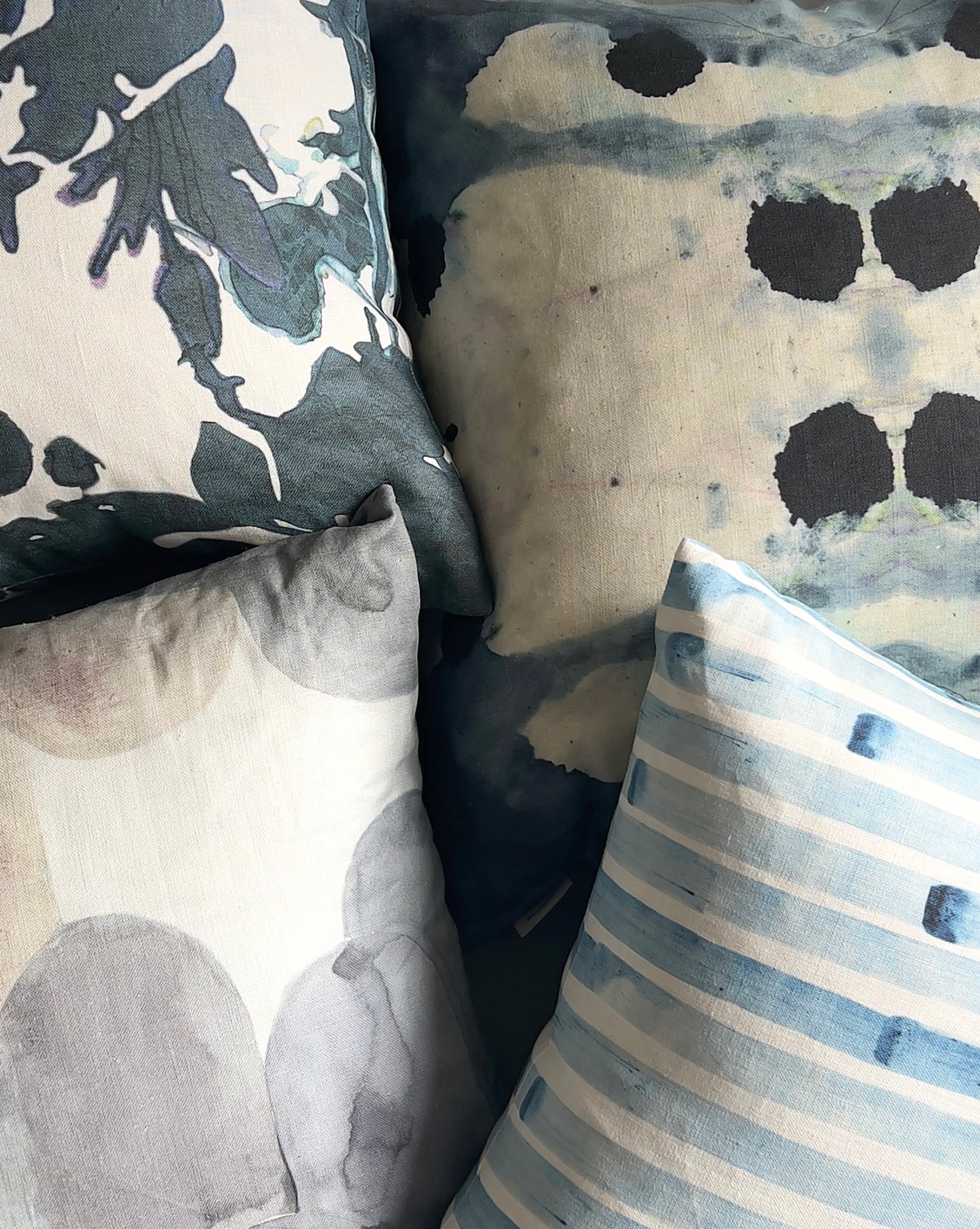 Close-up of patterned pillows with abstract designs.