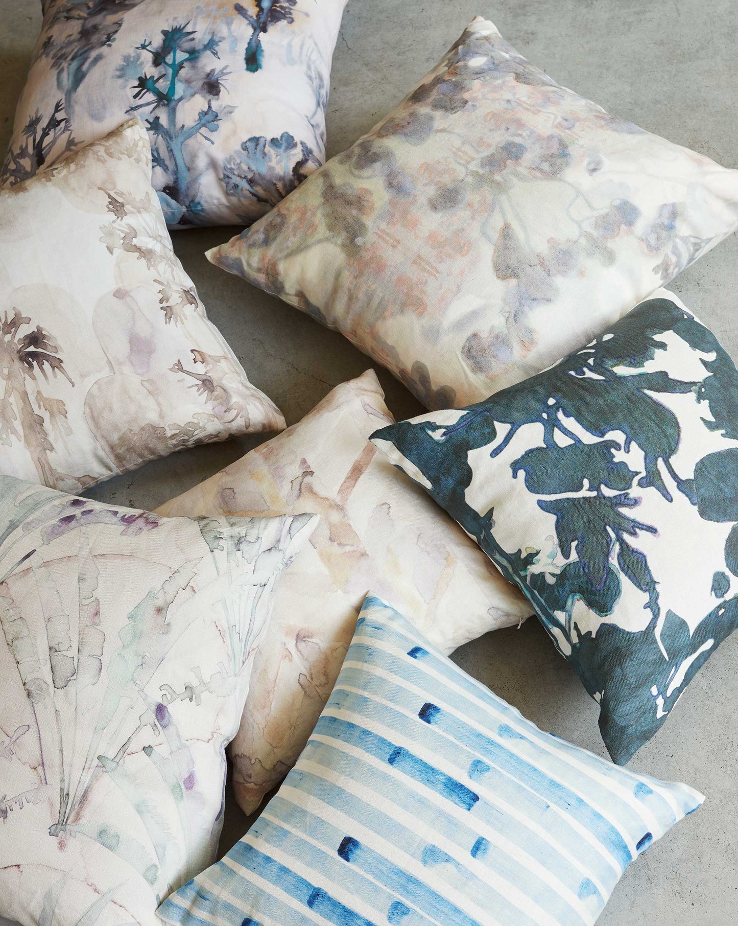 Set of decorative pillows with various patterns on a neutral background