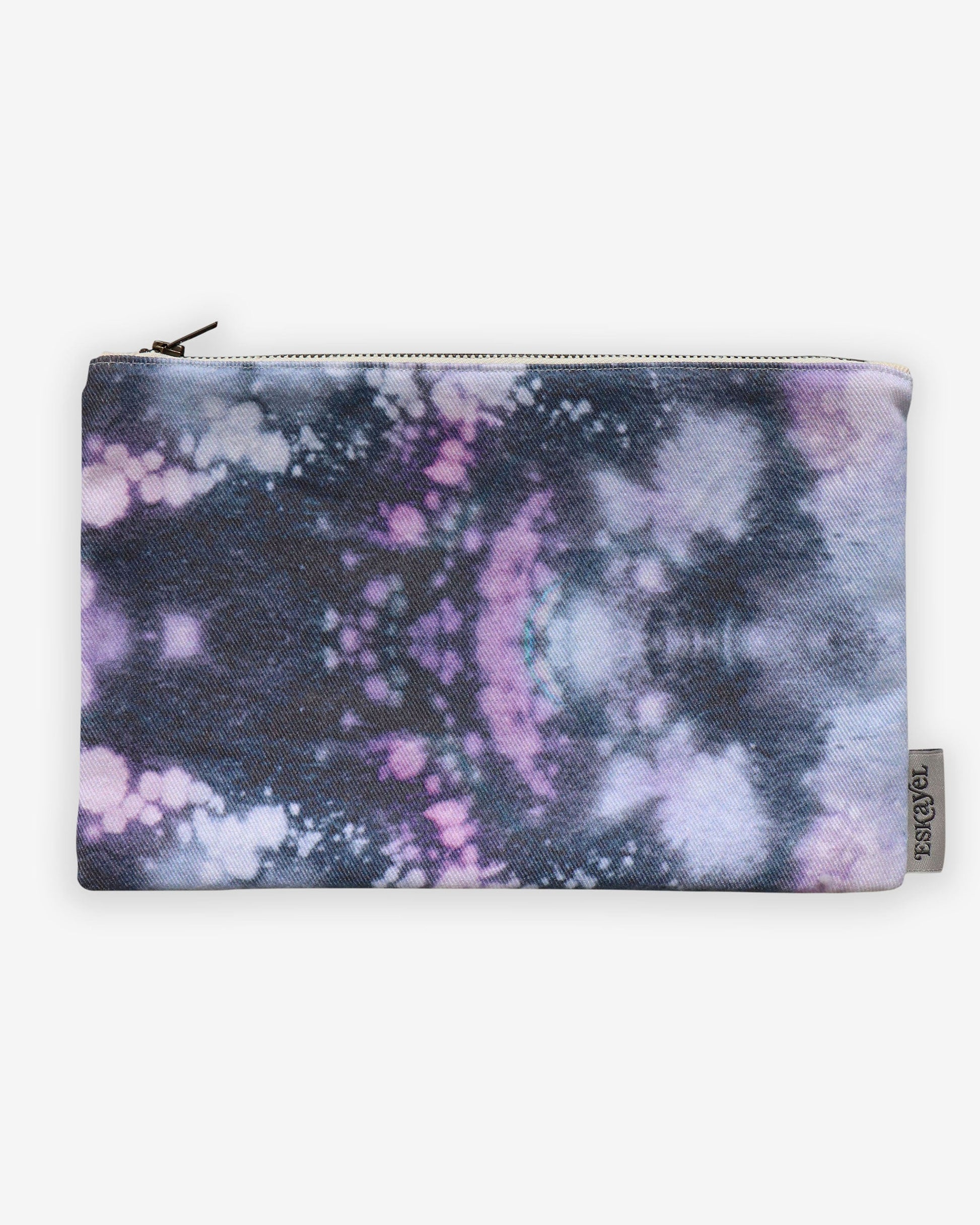 A purple and black Solar Pouch Beryl with a tie dye pattern, perfect for carrying small items