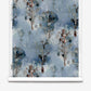 A roll of Aionas Silk Wallcovering in Thalassa, featuring a blue watercolor pattern of silhouetted trees and organic, nature-inspired shapes.